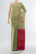 Sage Green Soft Silk Saree with Zari Butta on the body and Without Border.  displayed on a mannequin