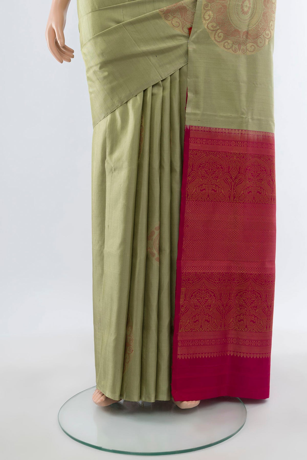 Pleats and pallu of Sage Green Soft Silk Saree with Zari Butta on the body and Without Border. 