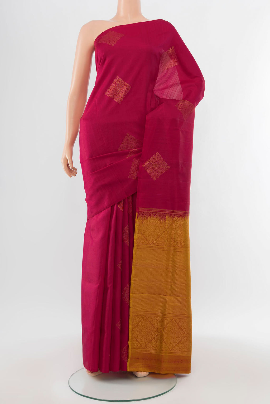 Maroon Soft Silk Saree with Zari Butta on the body and Silk Border.  displayed on a mannequin
