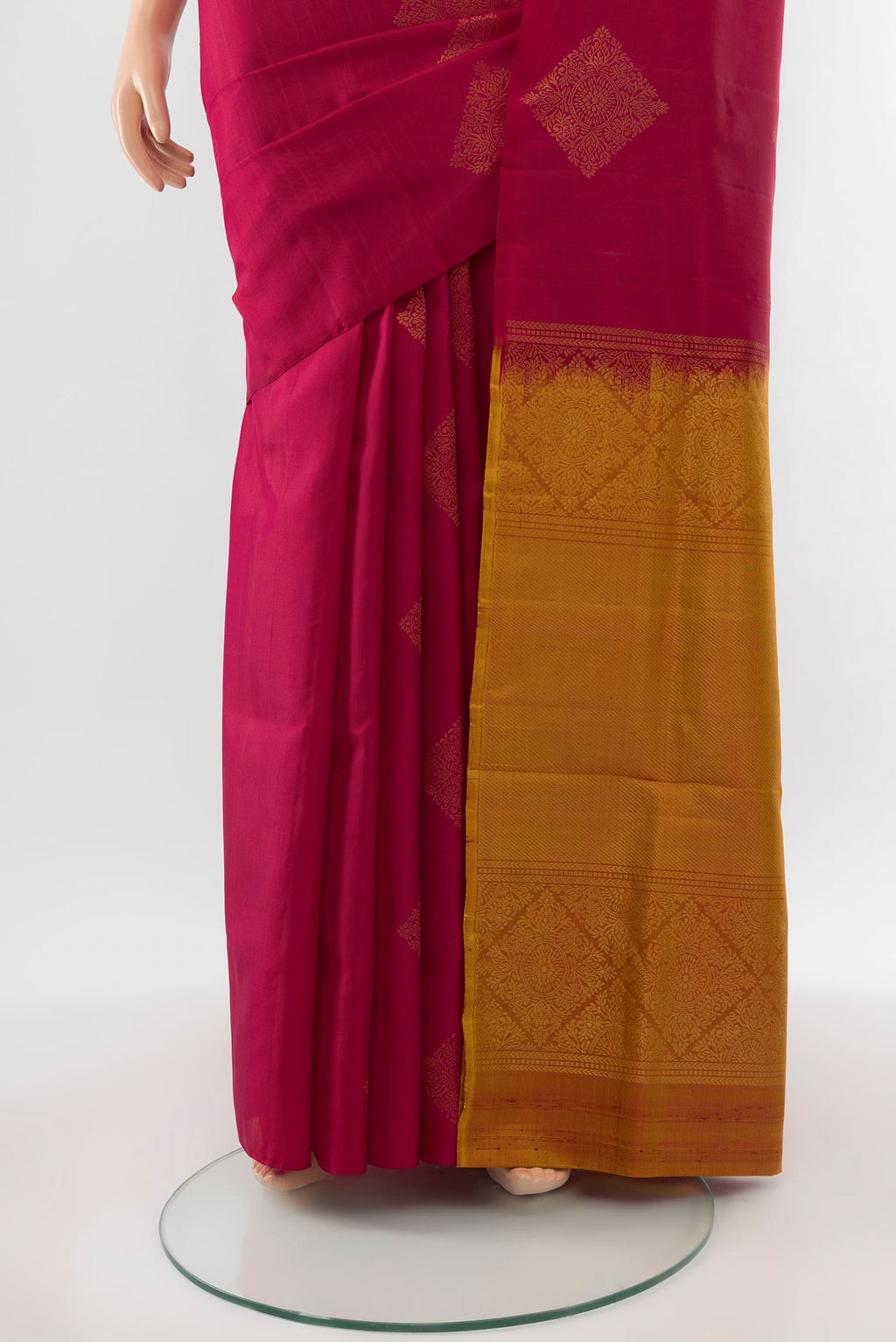 Pleats and pallu of Maroon Soft Silk Saree with Zari Butta on the body and Silk Border. 