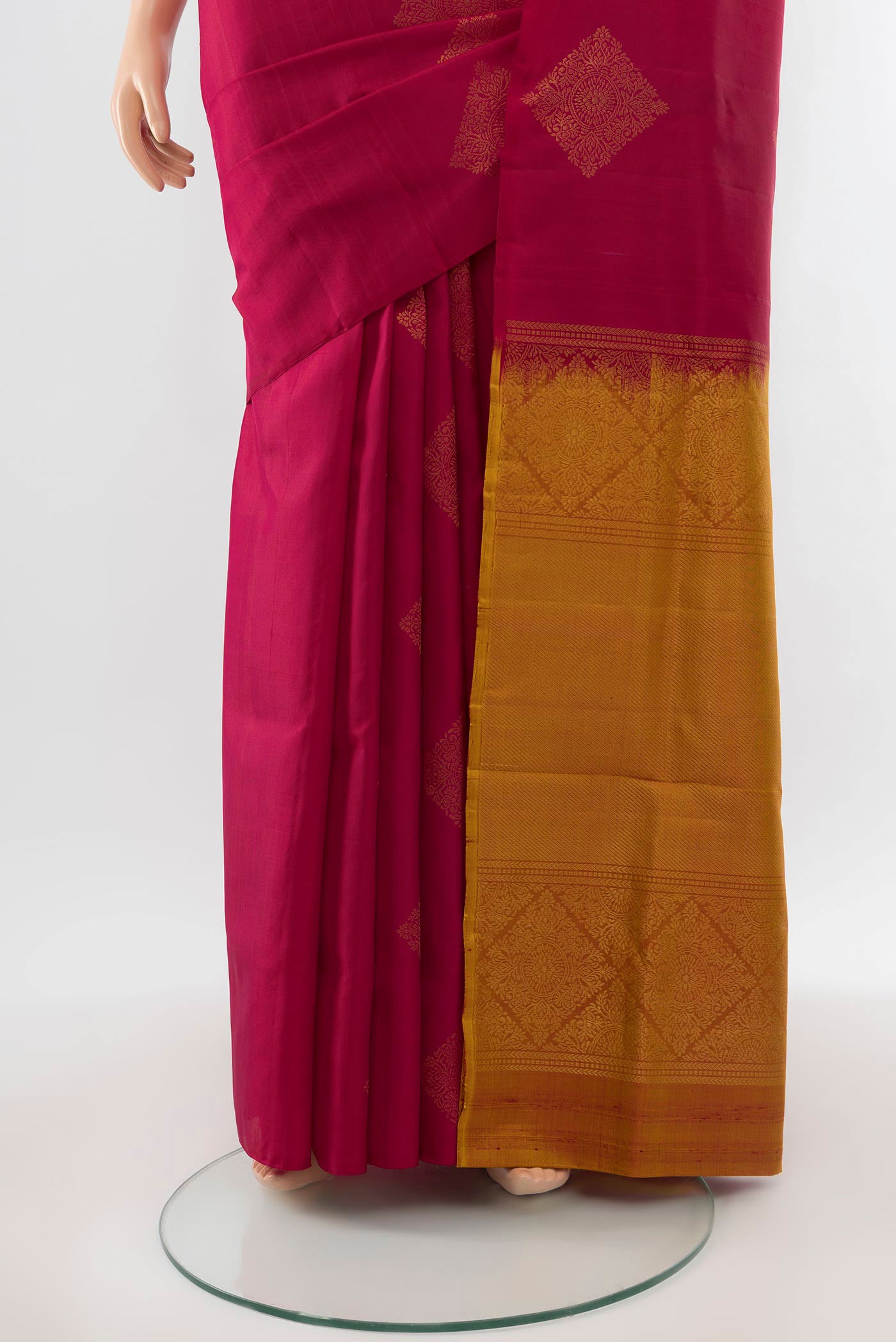 Pleats and pallu of Maroon Soft Silk Saree with Zari Butta on the body and Silk Border. 