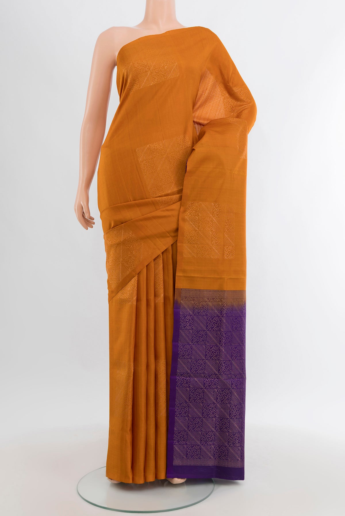 Brick Orange Soft Silk Saree with Zari Butta on the body and Without Border.  displayed on a mannequin