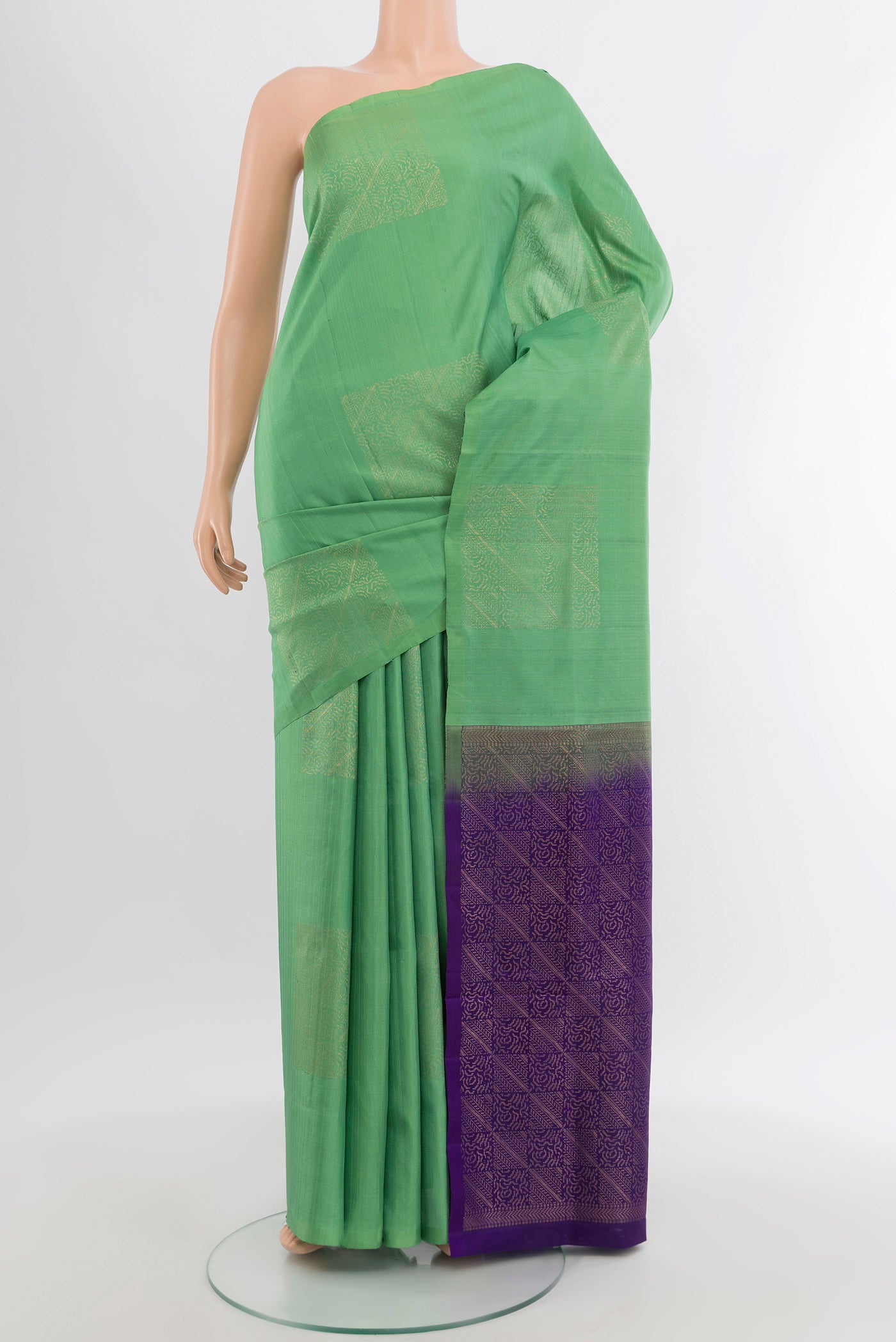 Green Soft Silk Saree with Zari Butta on the body and Without Border.  displayed on a mannequin