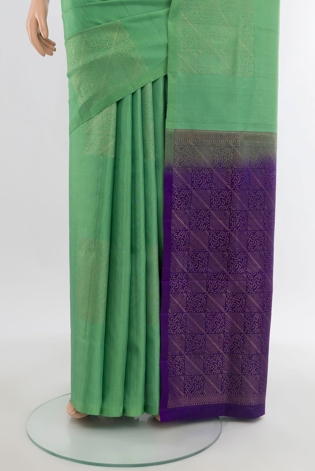Pleats and pallu of Green Soft Silk Saree with Zari Butta on the body and Without Border. 