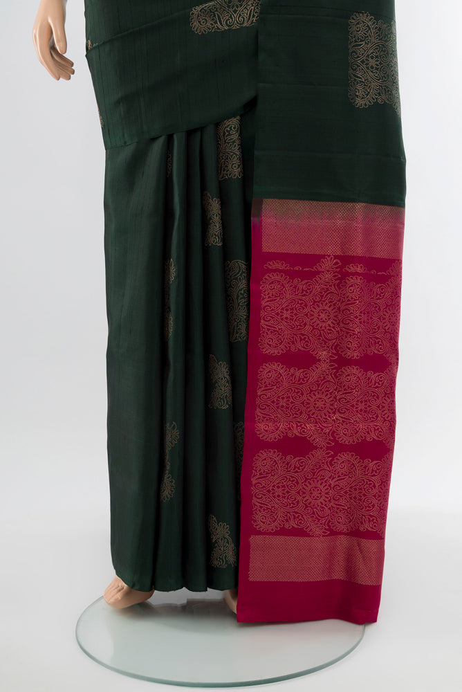 Pleats and pallu of Bottle Green Soft Silk Saree with Zari Butta on the body and Silk Border. 