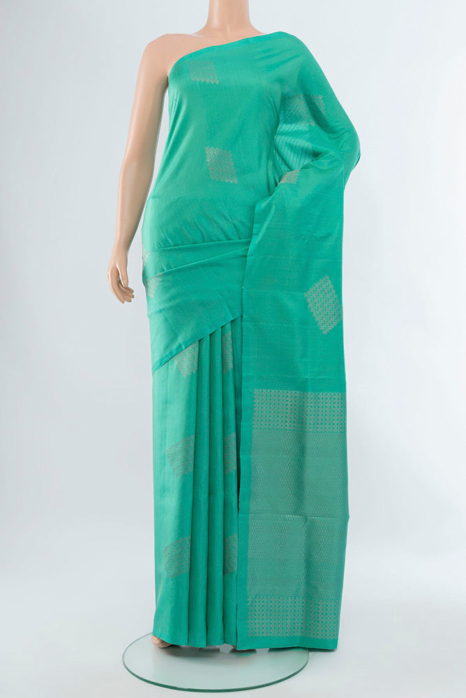 Sky Blue Soft Silk Saree with Zari Butta on the body and Silk Border.  displayed on a mannequin