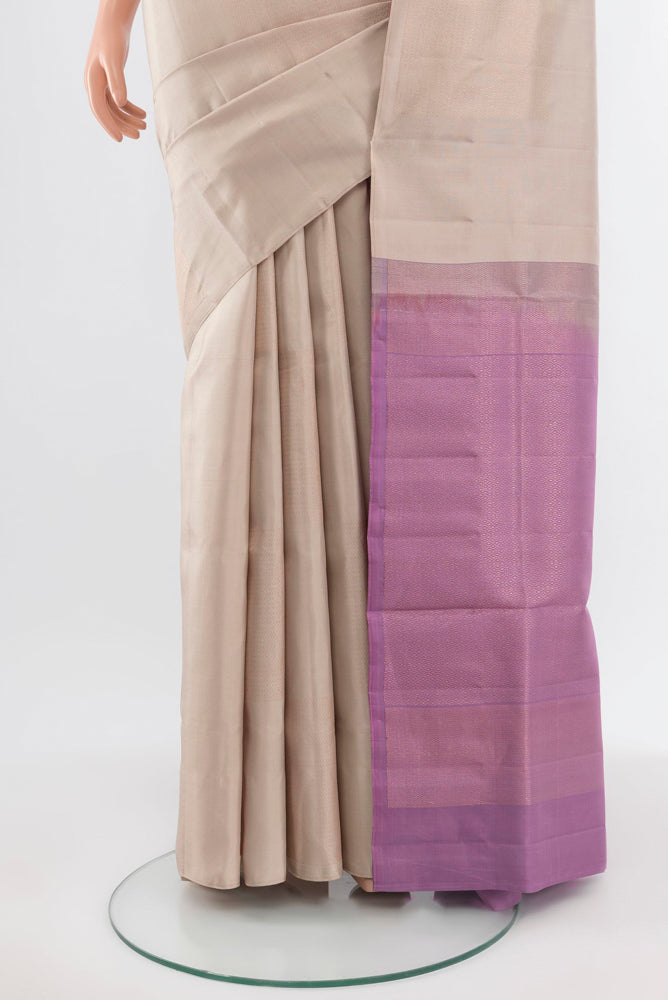 Pleats and pallu of Beige Soft Silk Saree with Zari Butta on the body and Silk Border. 