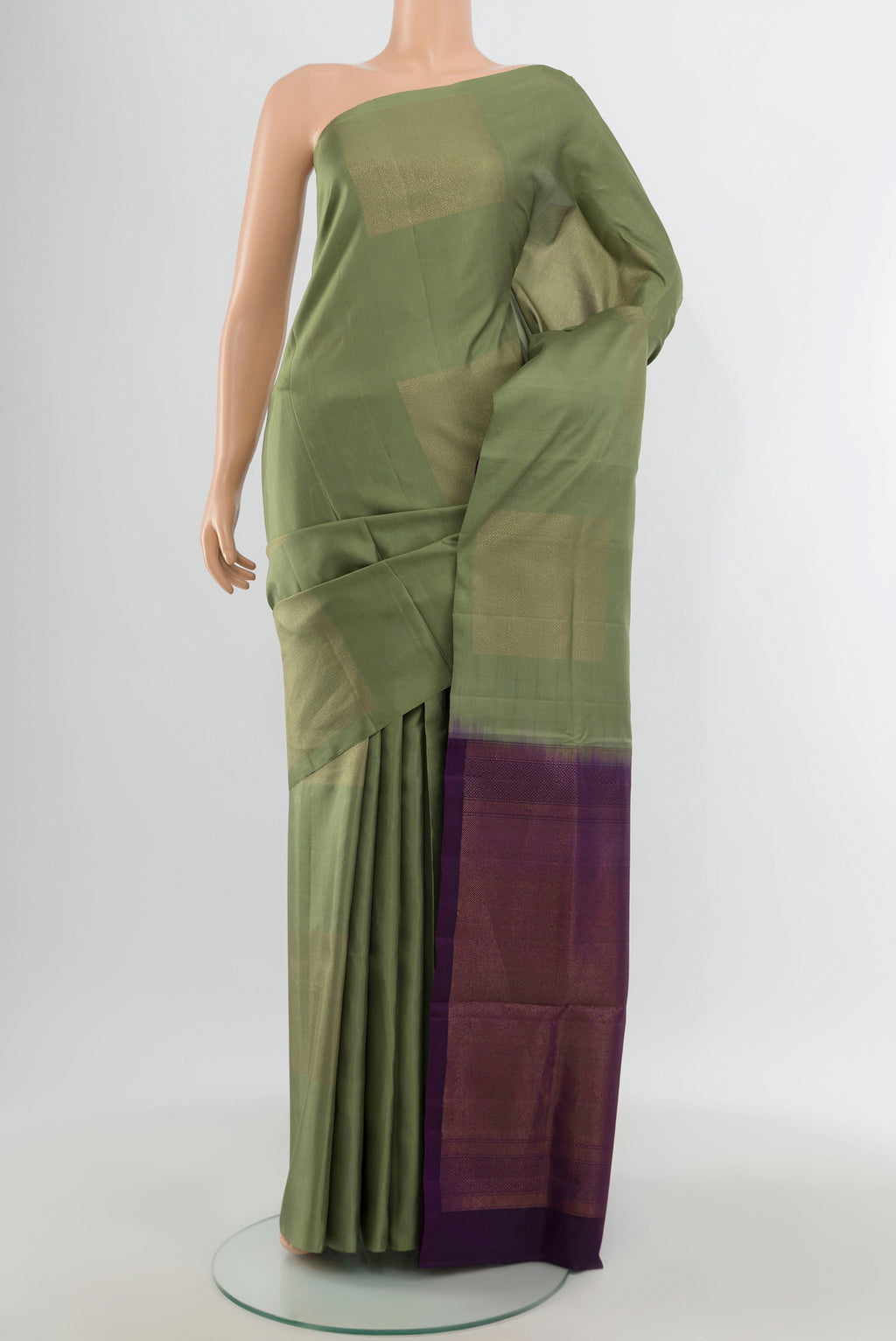 Sage Green Soft Silk Saree with Zari Butta on the body and Without Border.  displayed on a mannequin