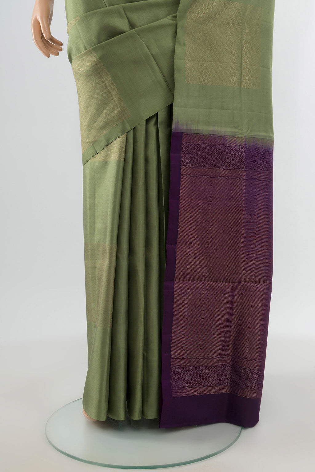Pleats and pallu of Sage Green Soft Silk Saree with Zari Butta on the body and Without Border. 
