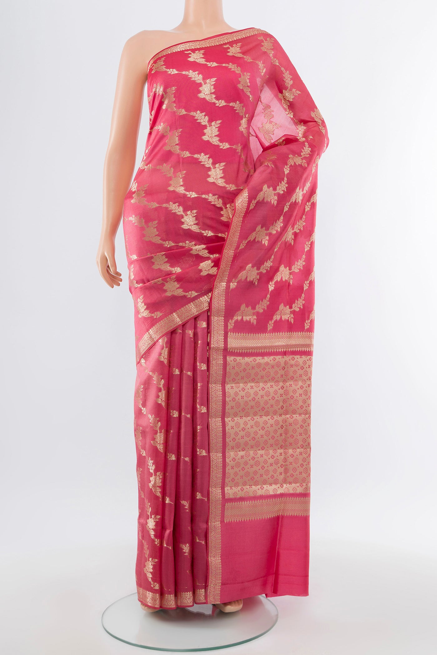 Rose Gold Banarasi Raw Silk Saree with Zari Butta on the body and Silk Border.  displayed on a mannequin