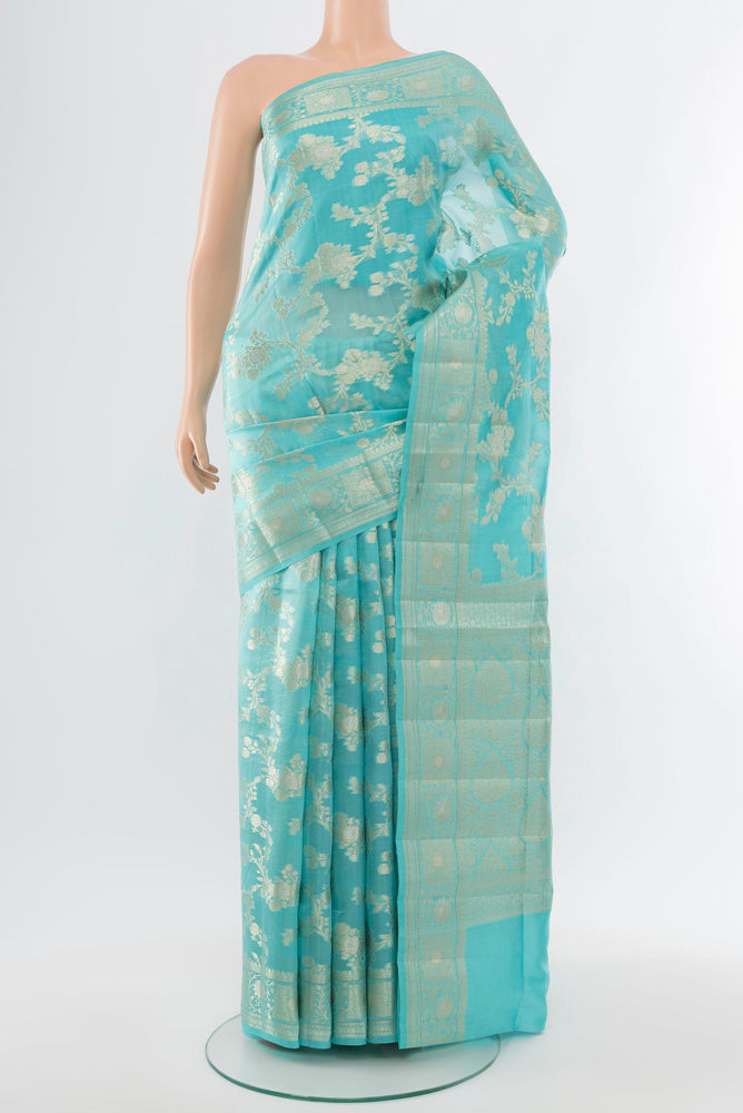 Sky Blue Banarasi Raw Silk Saree with Zari Butta on the body and Silk Border.  displayed on a mannequin