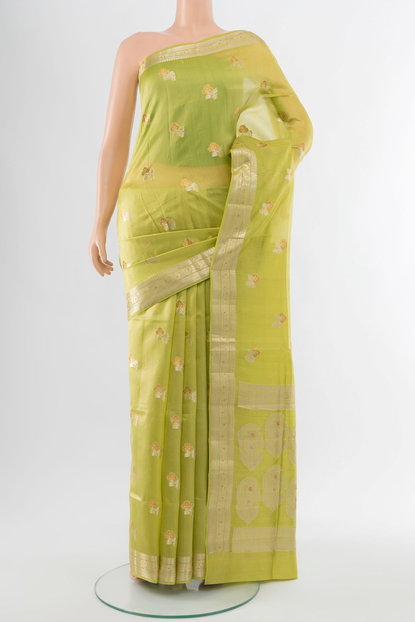 Pista Green Banarasi Raw Silk Saree with Zari Butta on the body and Silk Border.  displayed on a mannequin