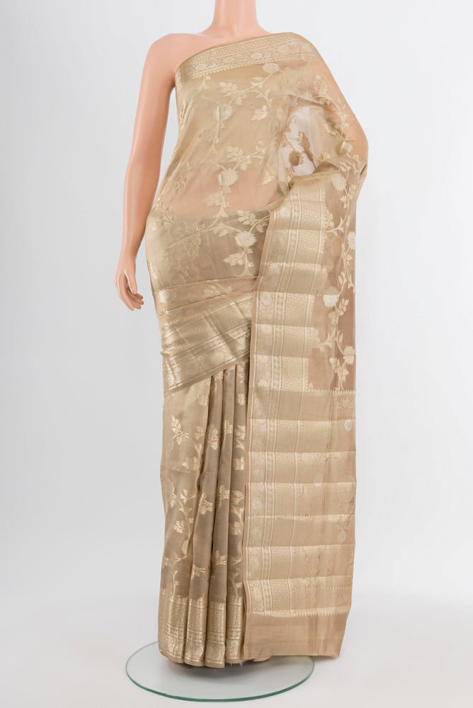 Dark Beige Banarasi Raw Silk Saree with Zari Butta on the body and Silk Border.  displayed on a mannequin