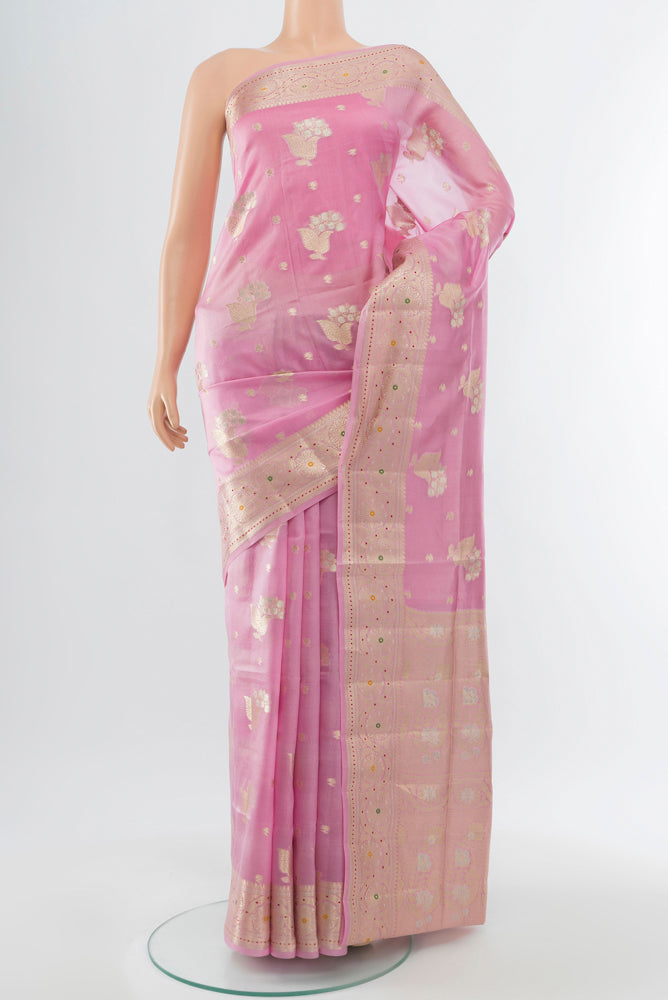 Rose Gold Banarasi Raw Silk Saree with Zari Butta on the body and Silk Border.  displayed on a mannequin