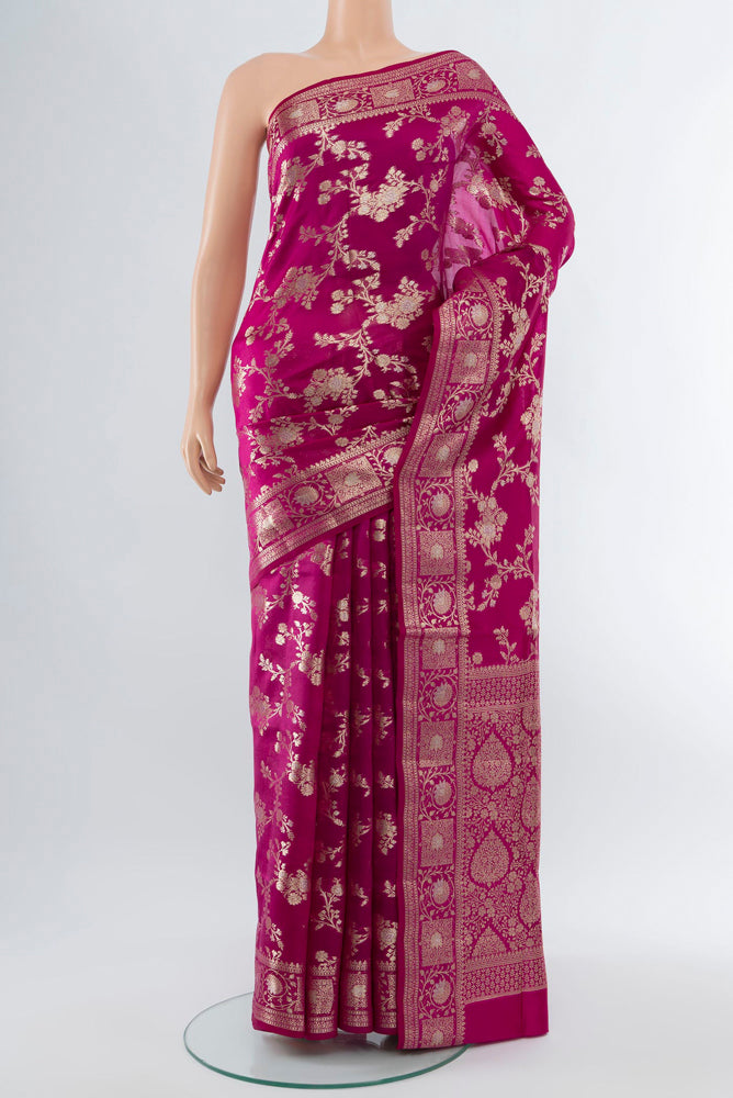 Magenta Banarasi Raw Silk Saree with Zari Butta on the body and Silk Border.  displayed on a mannequin
