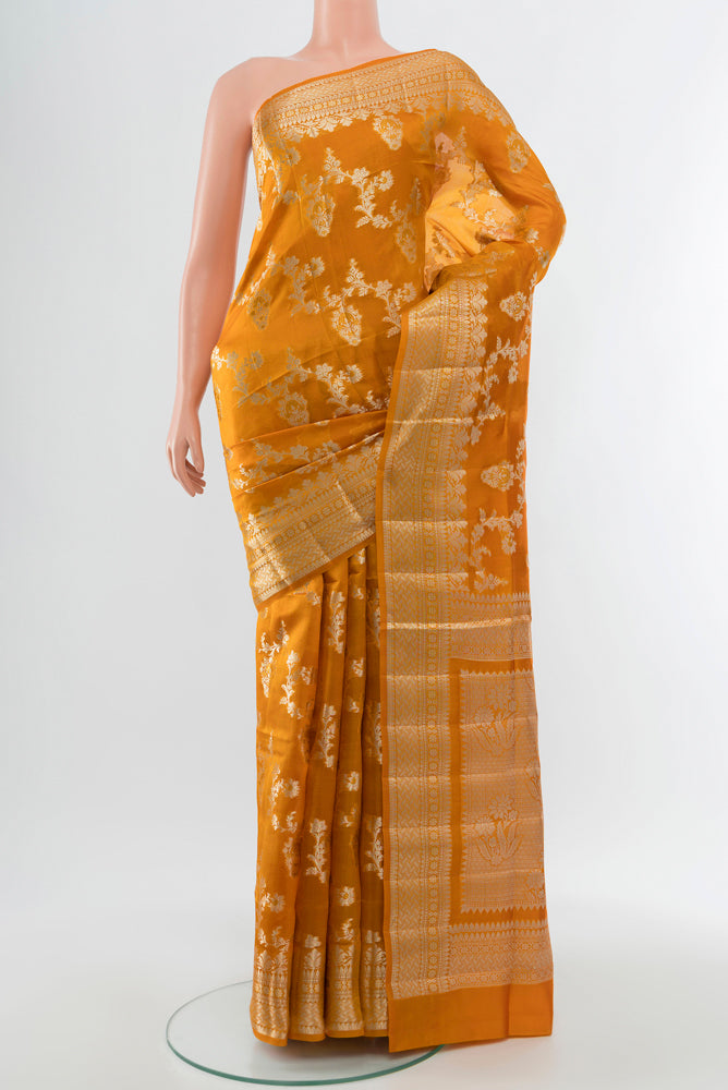 Mustard Banarasi Raw Silk Saree with Zari Butta on the body and Silk Border.  displayed on a mannequin