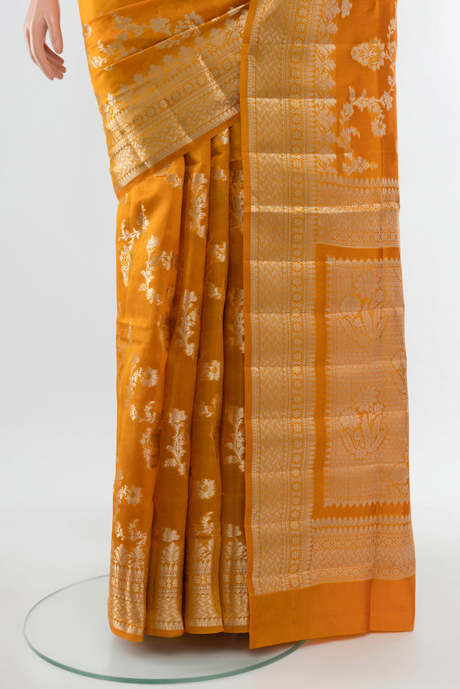 Pleats and pallu of Mustard Banarasi Raw Silk Saree with Zari Butta on the body and Silk Border. 