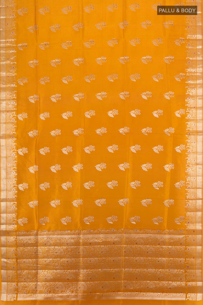 Flat view of Mustard Banarasi Raw Silk Saree with Zari Butta on the body and Silk Border. 