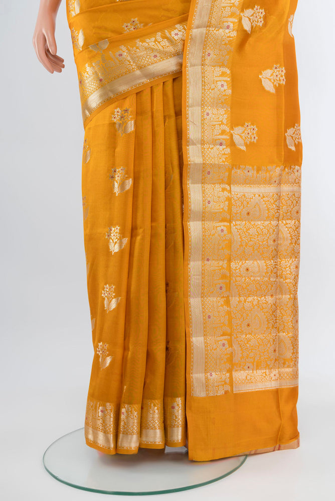 Pleats and pallu of Mustard Banarasi Raw Silk Saree with Zari Butta on the body and Silk Border. 