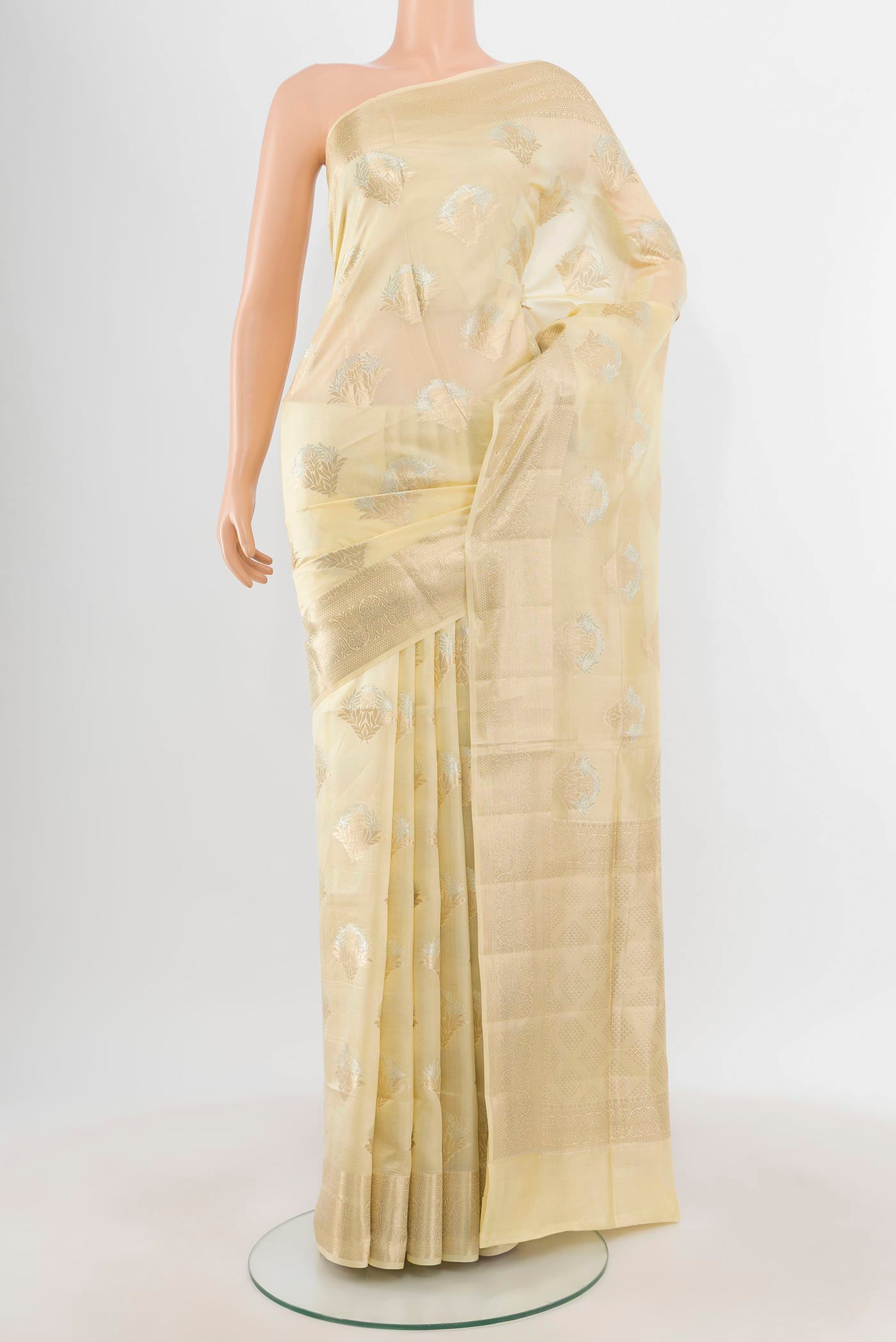 Cream Banarasi Raw Silk Saree with Zari Butta on the body and Zari Border.  displayed on a mannequin