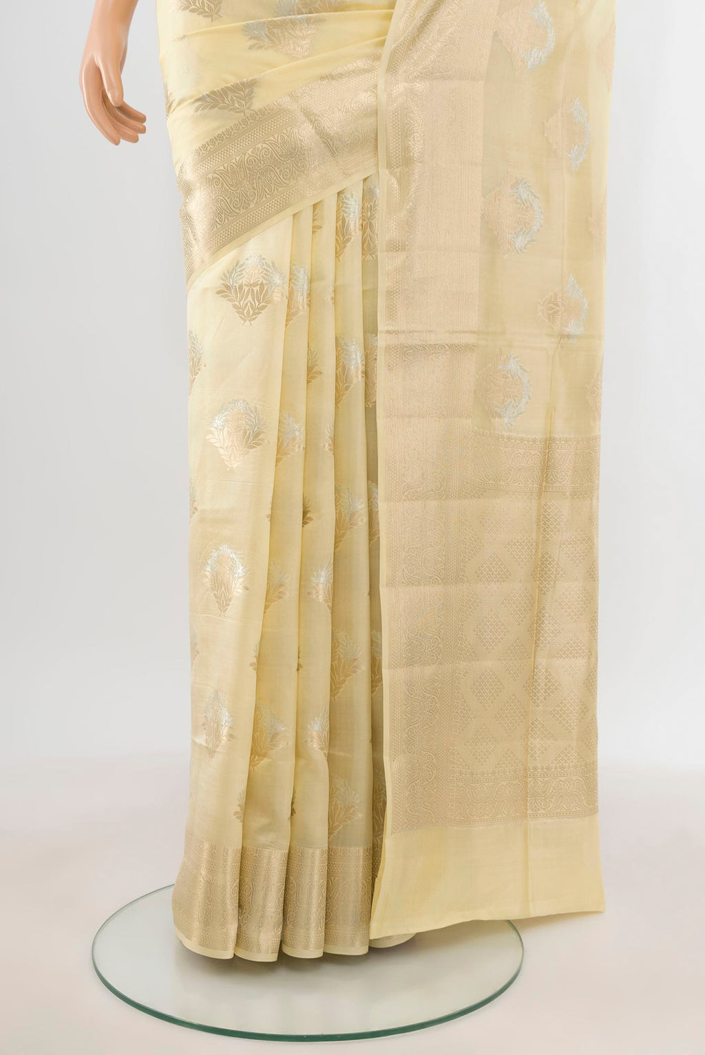 Pleats and pallu of Cream Banarasi Raw Silk Saree with Zari Butta on the body and Zari Border. 