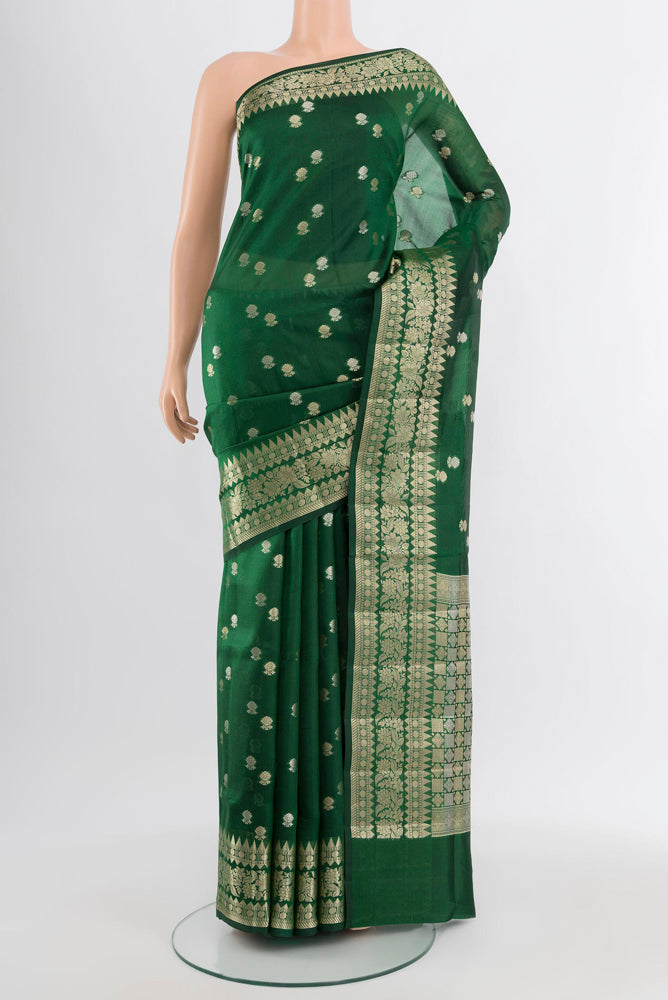 Bottle Green Banarasi Raw Silk Saree with Zari Butta on the body and Silk Border.  displayed on a mannequin