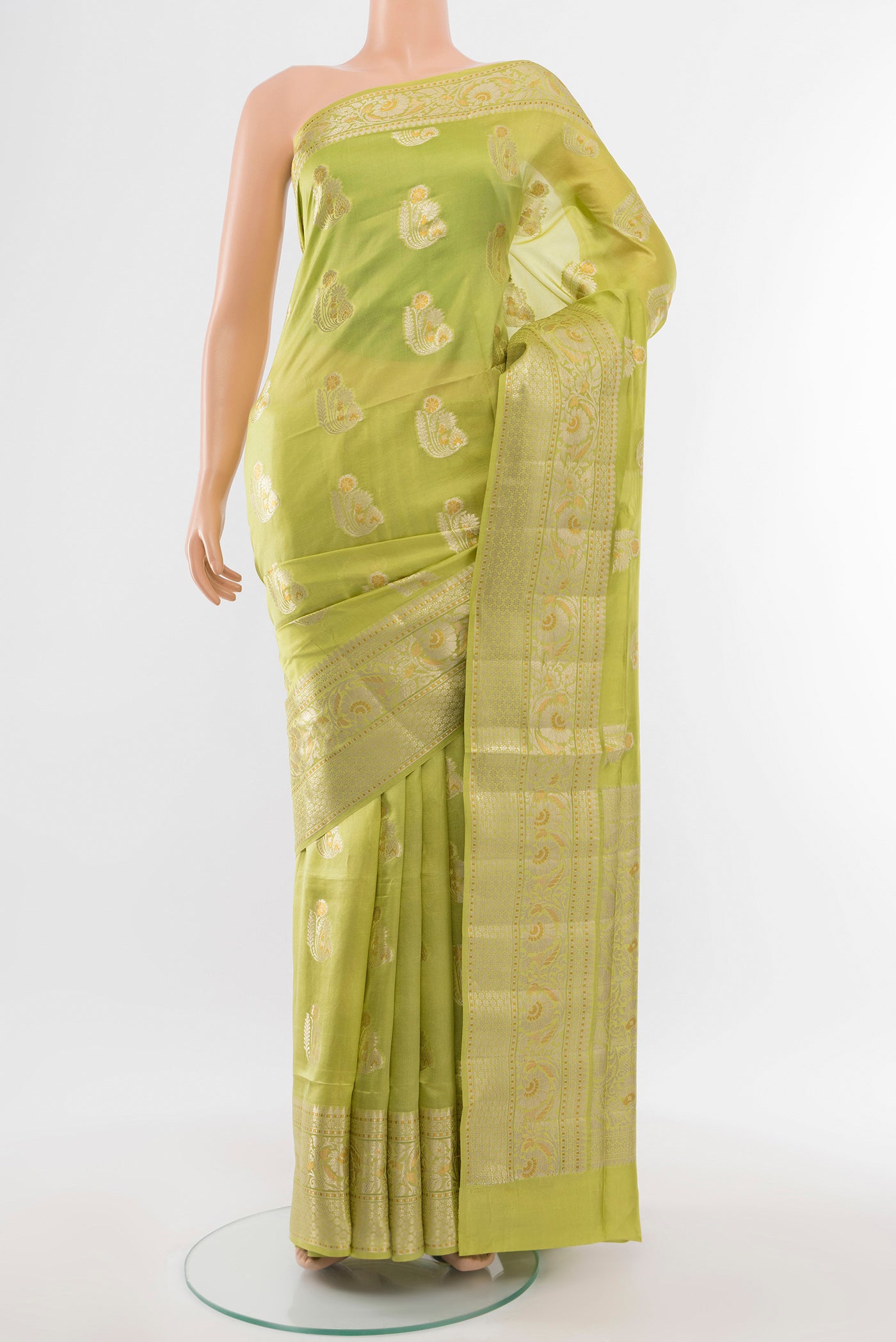 Pista Green Banarasi Raw Silk Saree with Zari Butta on the body and Silk Border.  displayed on a mannequin