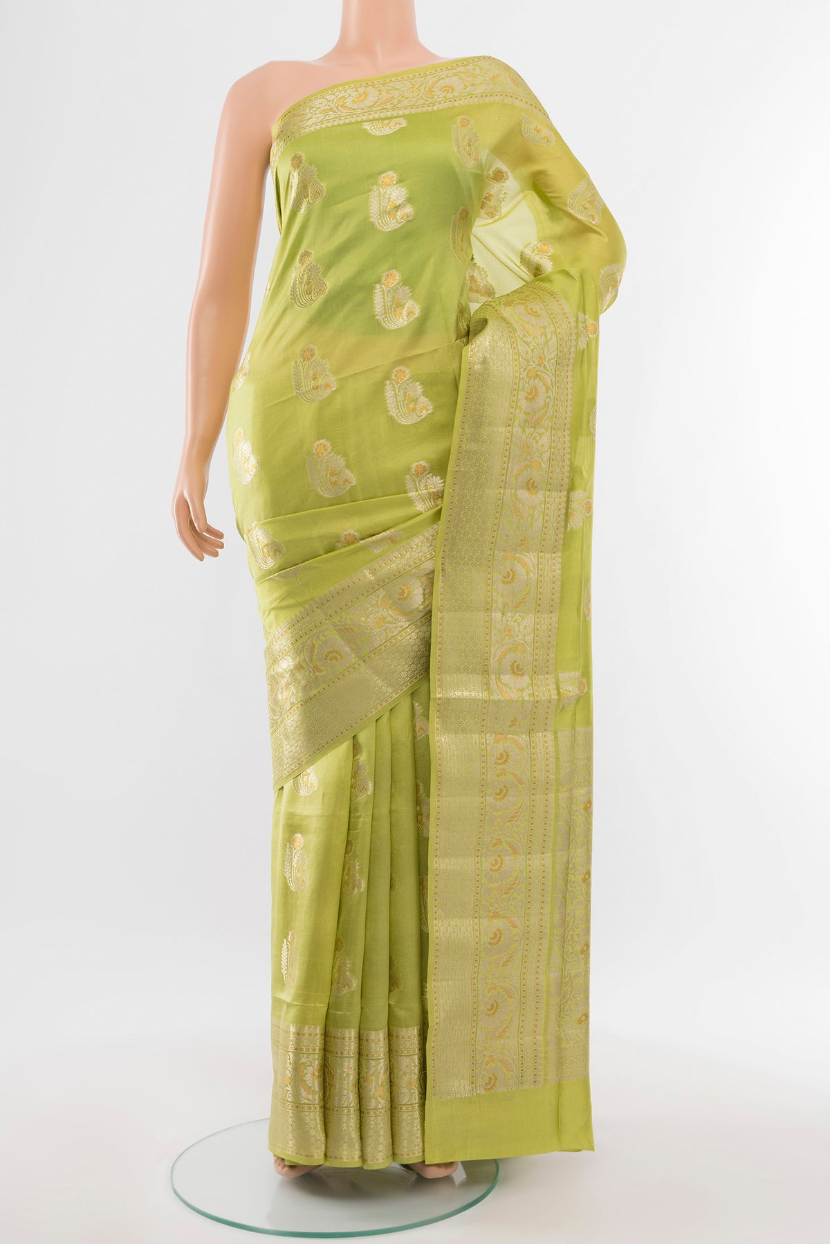 Pista Green Banarasi Raw Silk Saree with Zari Butta on the body and Silk Border.  displayed on a mannequin