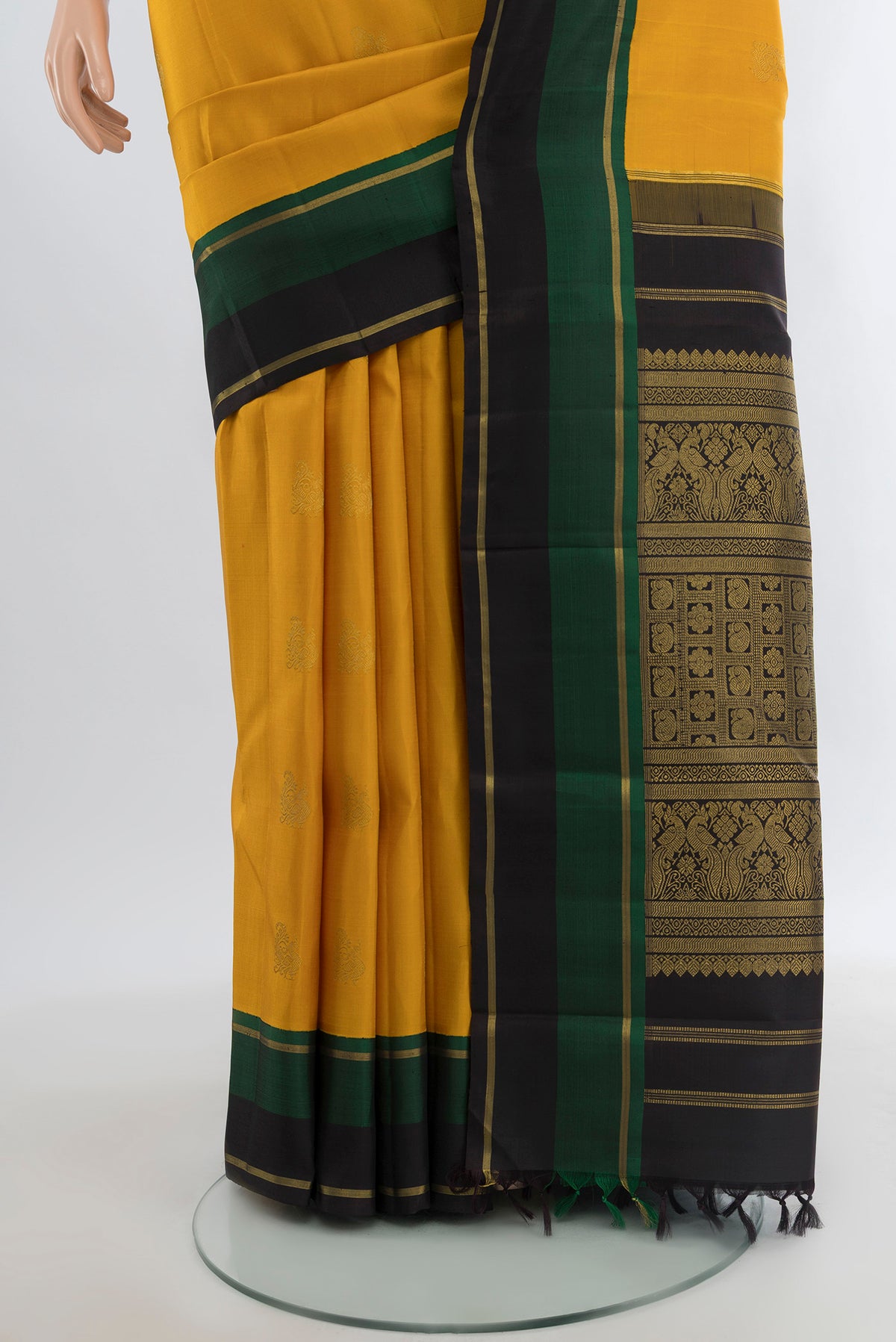 Pleats and pallu of Pure Silk Pure Zari Mustard Kanjivaram Saree with Zari Butta on the body and Plain Border. 