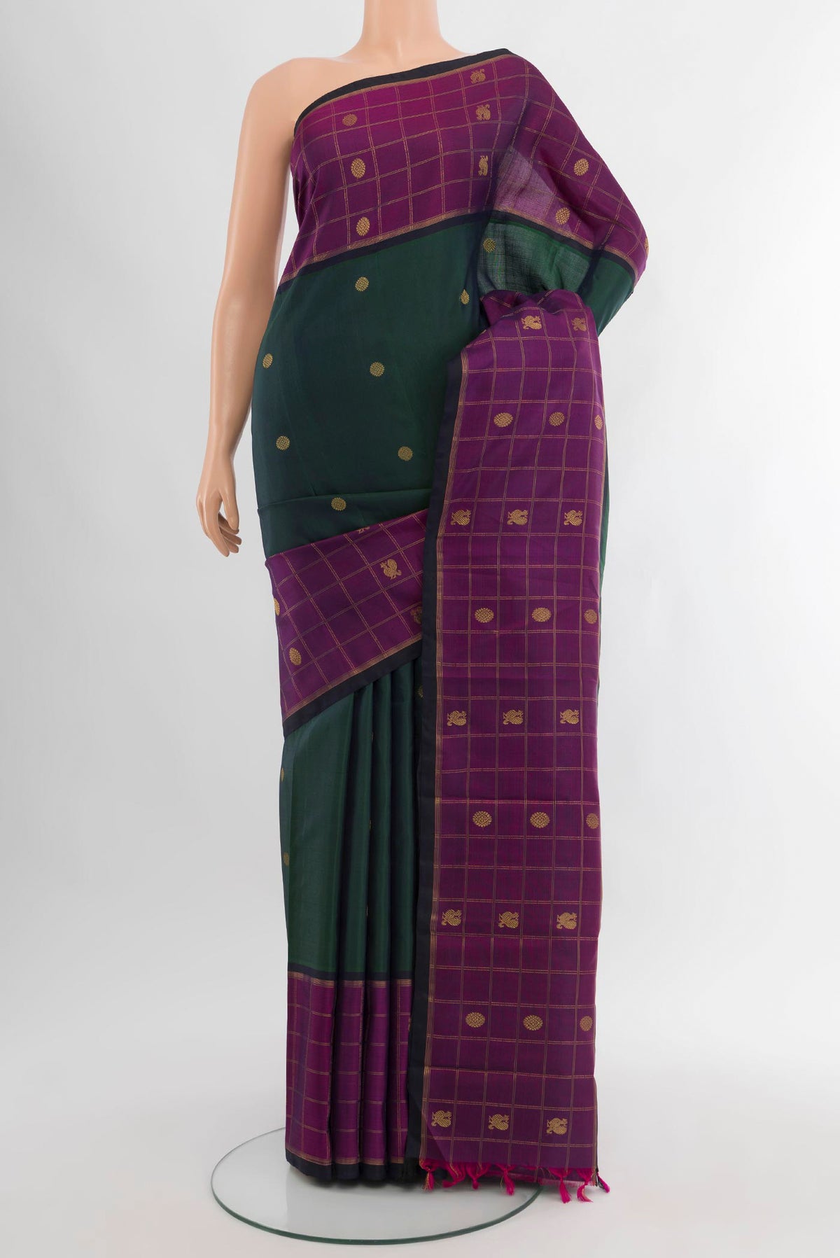 Pure Silk Pure Zari Bottle Green Kanjivaram Saree with Zari Butta on the body and Zari Border.  displayed on a mannequin