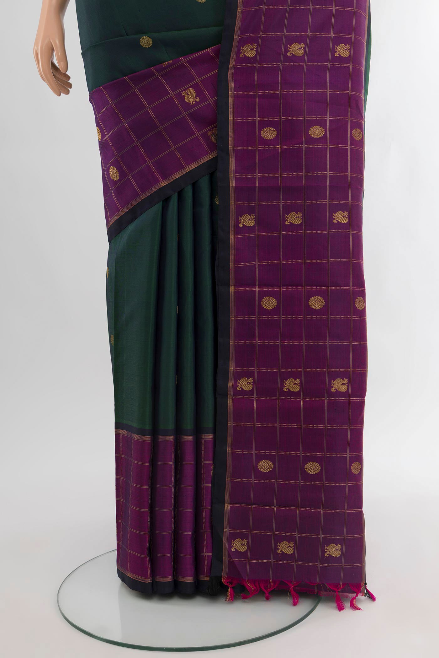 Pleats and pallu of Pure Silk Pure Zari Bottle Green Kanjivaram Saree with Zari Butta on the body and Zari Border. 