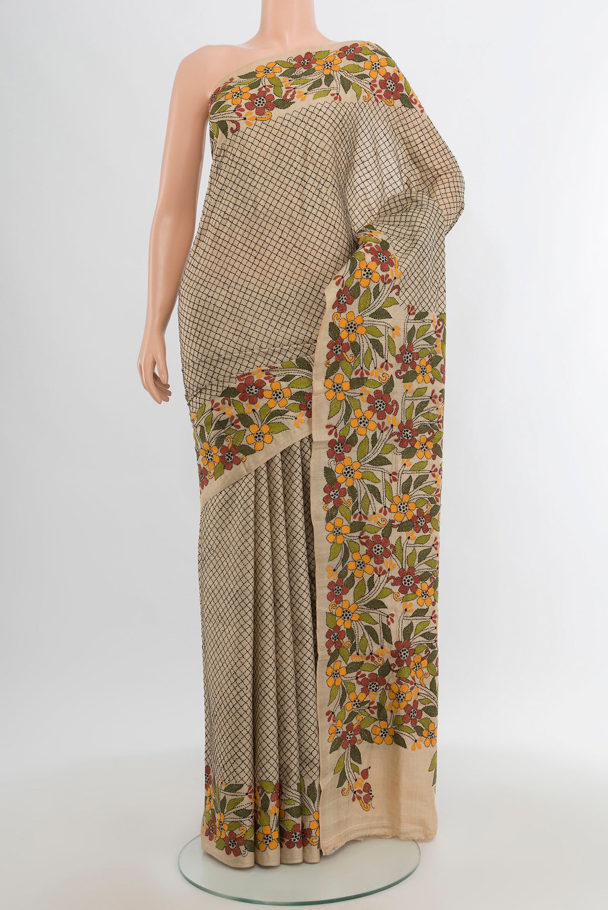 Beige Tussar Silk Saree with Embroidery on the body and Embroidery Border.  displayed on a mannequin