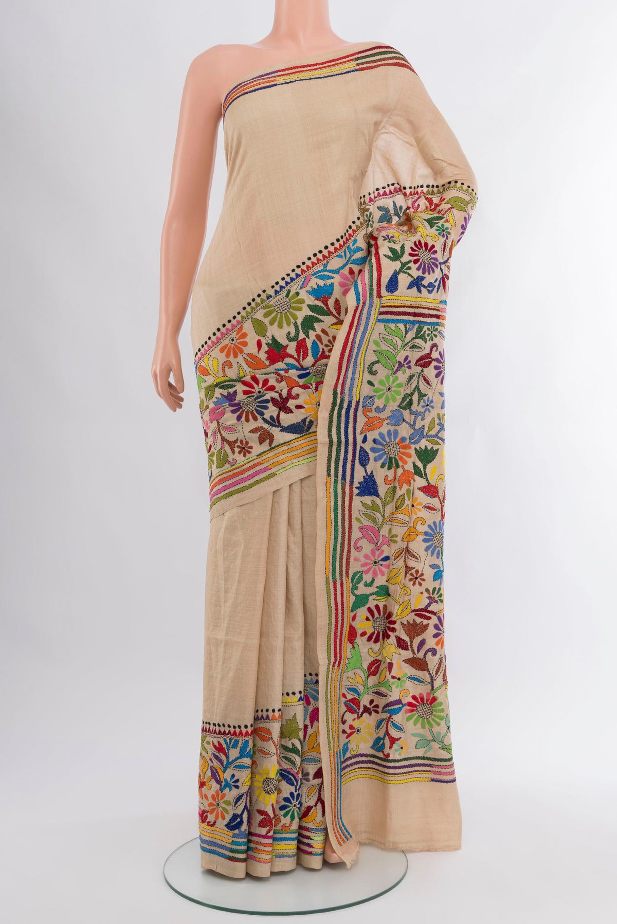 Beige Tussar Silk Saree with Embroidery on the body and Embroidery Border.  displayed on a mannequin