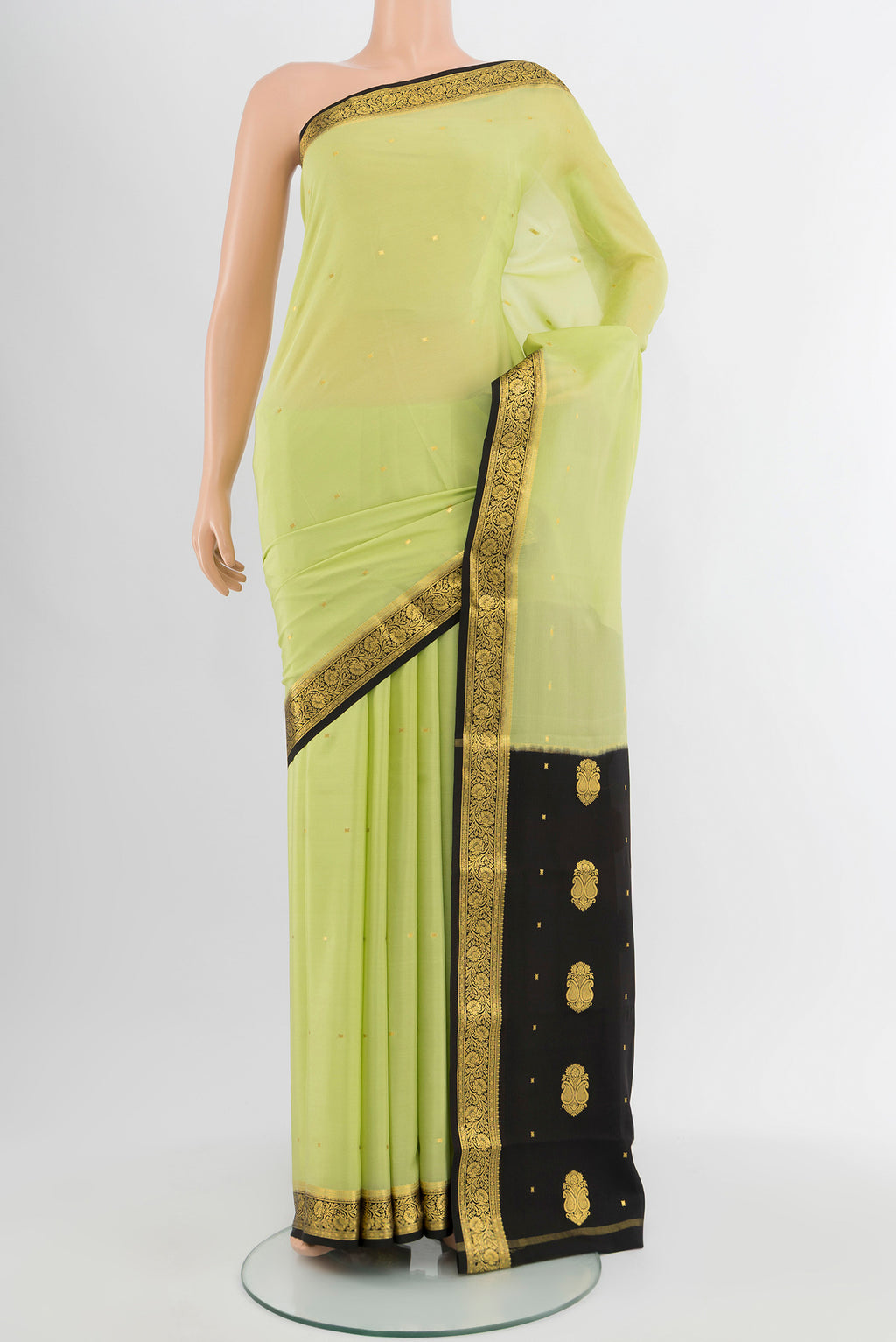 Pista Green Mysore Crepe Saree with Plain Body and Silk Border.  displayed on a mannequin