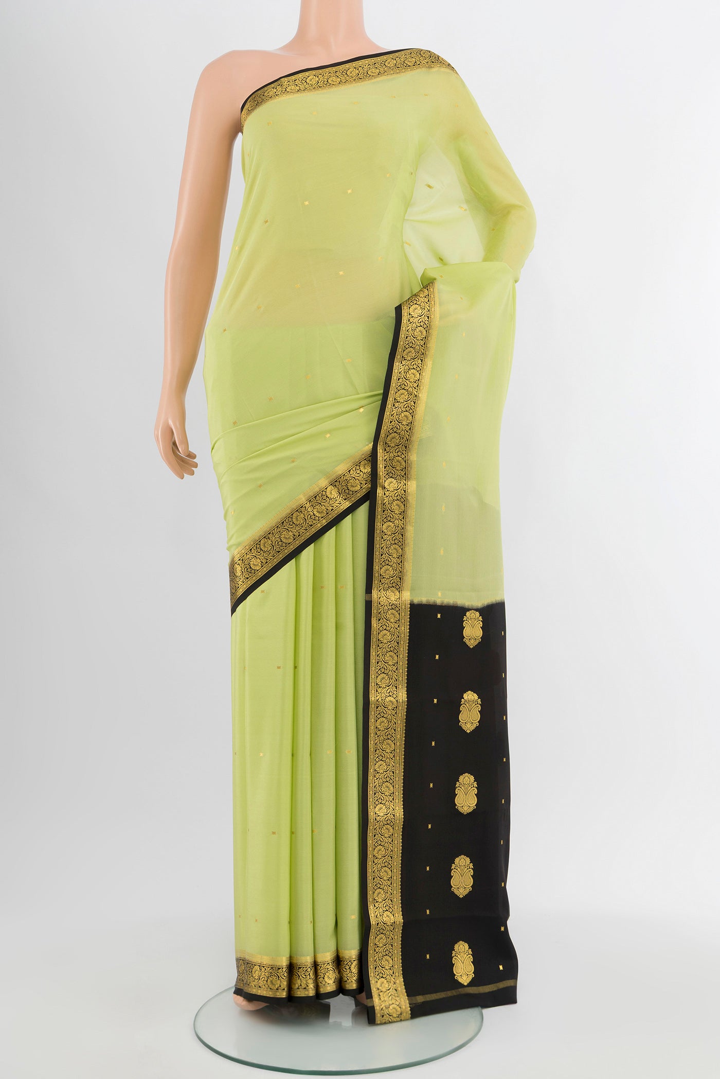Pista Green Mysore Crepe Saree with Plain Body and Silk Border.  displayed on a mannequin