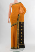 Mustard Mysore Crepe Saree with Zari Butta on the body and Silk Border.  displayed on a mannequin