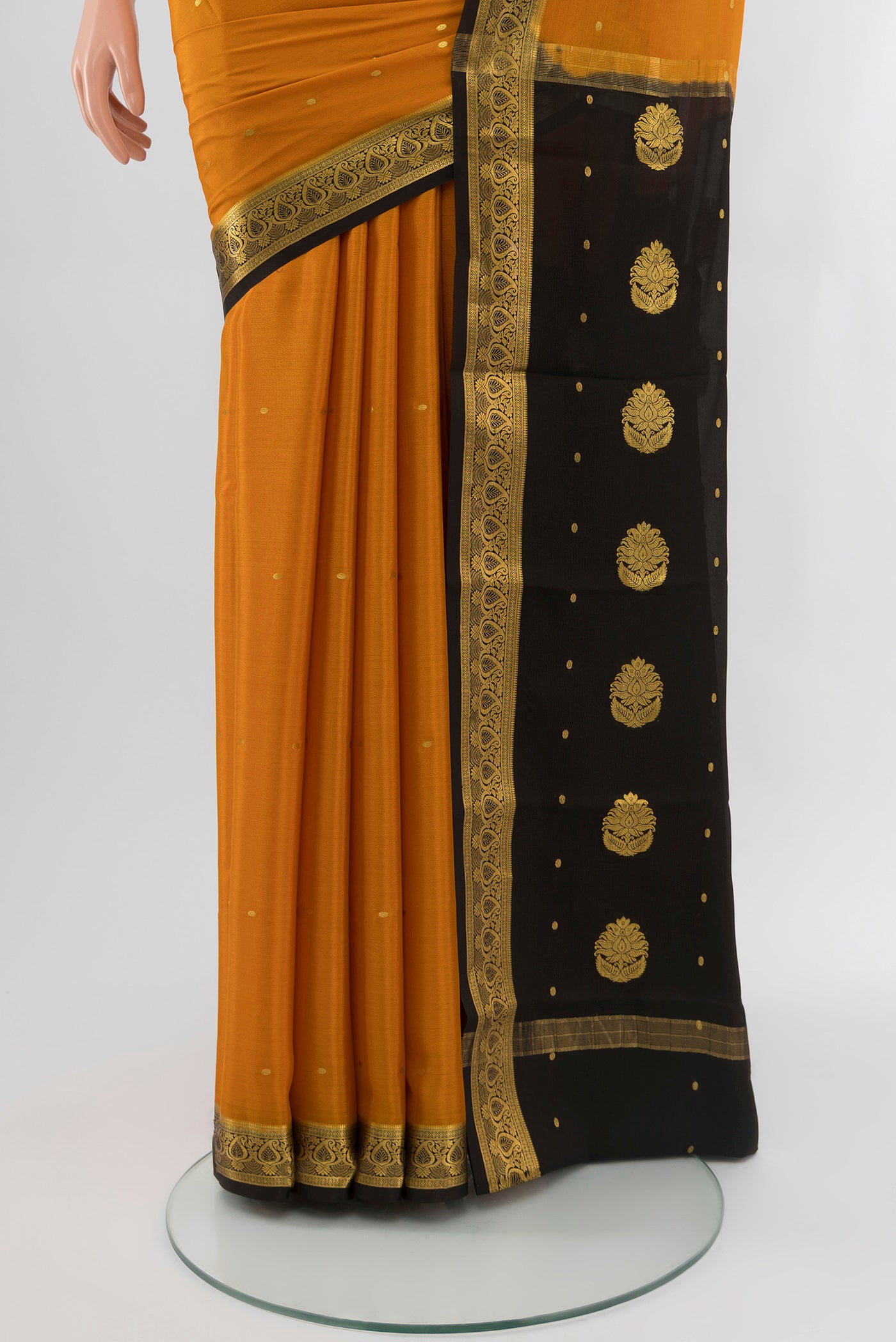 Pleats and pallu of Mustard Mysore Crepe Saree with Zari Butta on the body and Silk Border. 