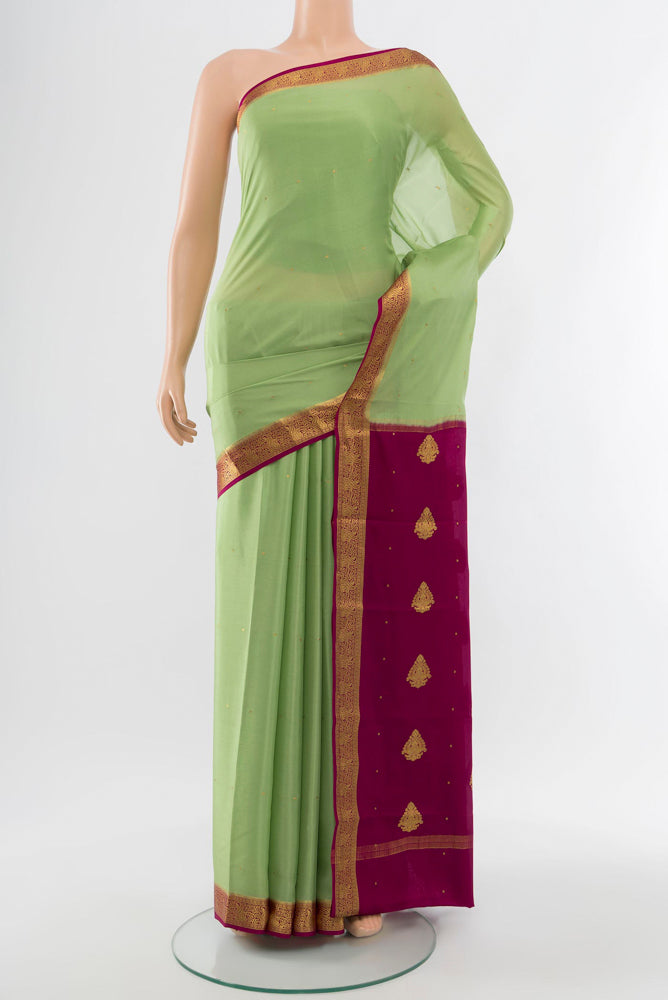 Pista Green Mysore Crepe Saree with Plain Body and Silk Border.  displayed on a mannequin