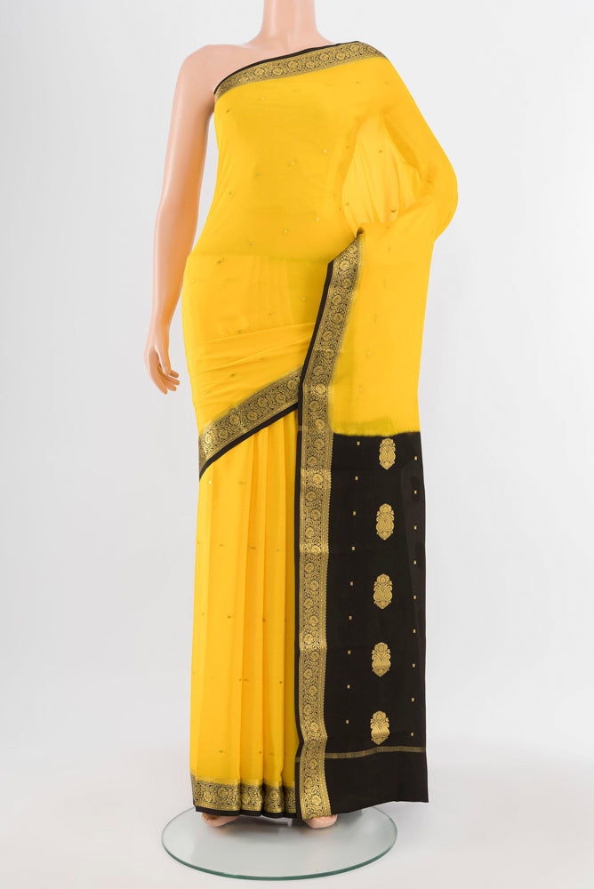 Yellow Mysore Crepe Saree with Zari Butta on the body and Silk Border.  displayed on a mannequin