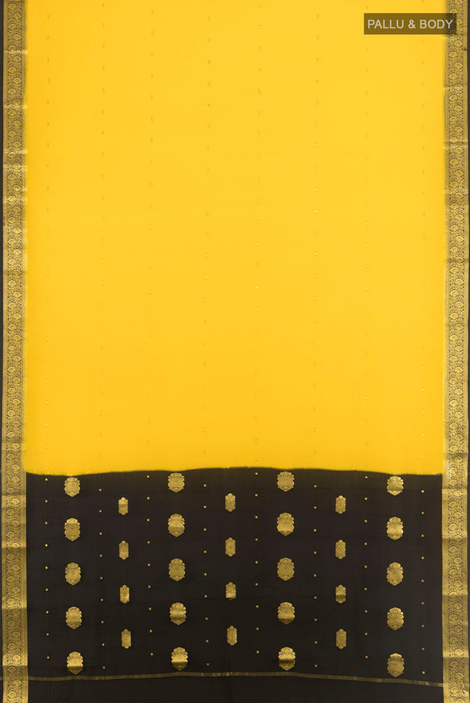 Flat view of Yellow Mysore Crepe Saree with Zari Butta on the body and Silk Border. 