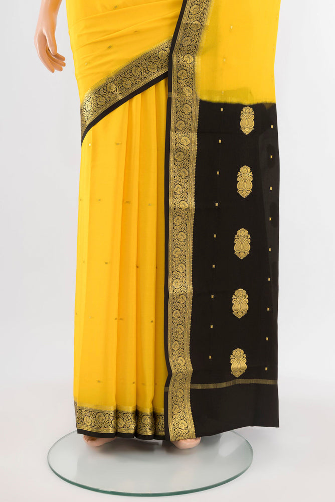 Pleats and pallu of Yellow Mysore Crepe Saree with Zari Butta on the body and Silk Border. 