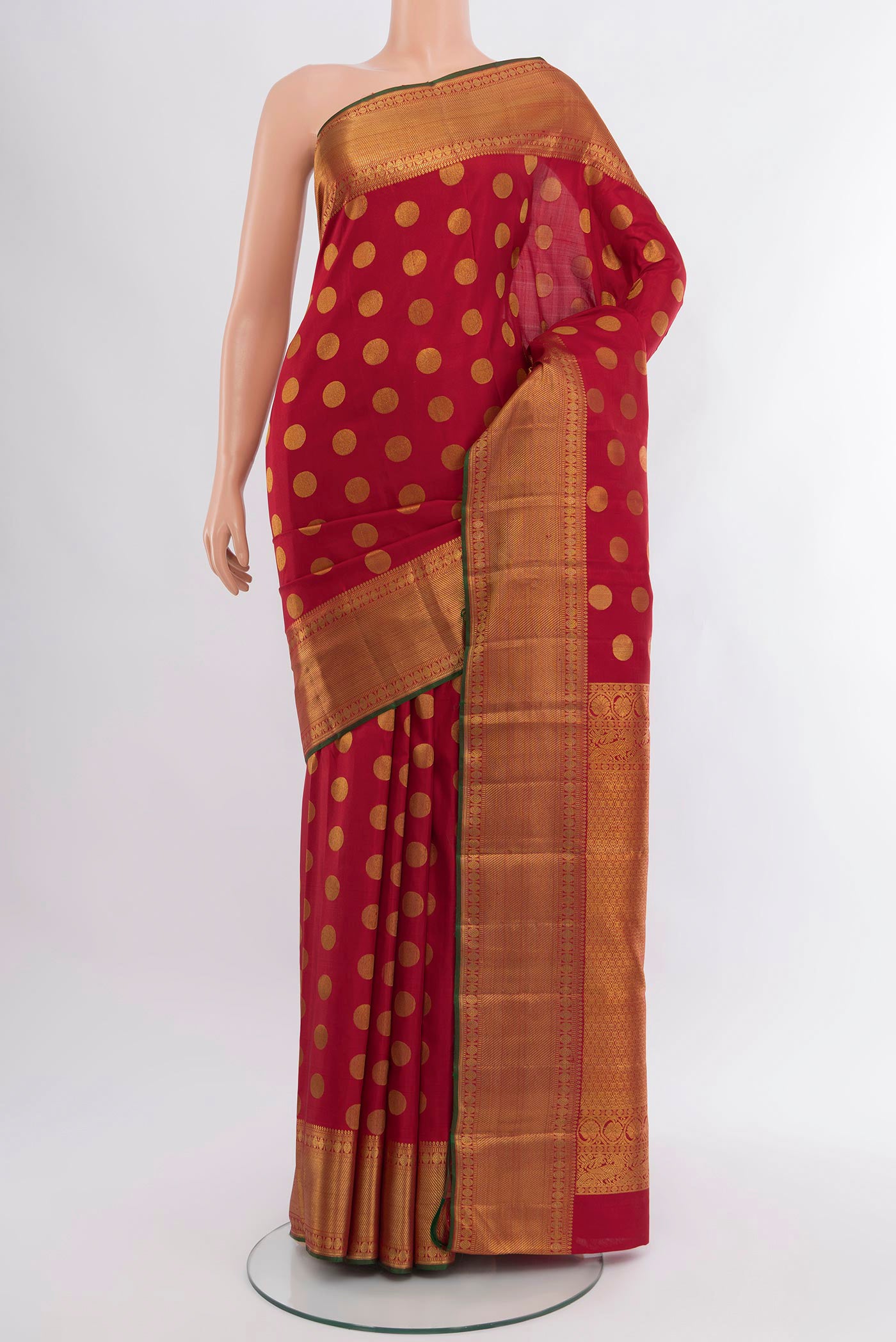 Maroon Kanchipuram Silk Saree with Zari Butta on the body and Zari Border.  displayed on a mannequin