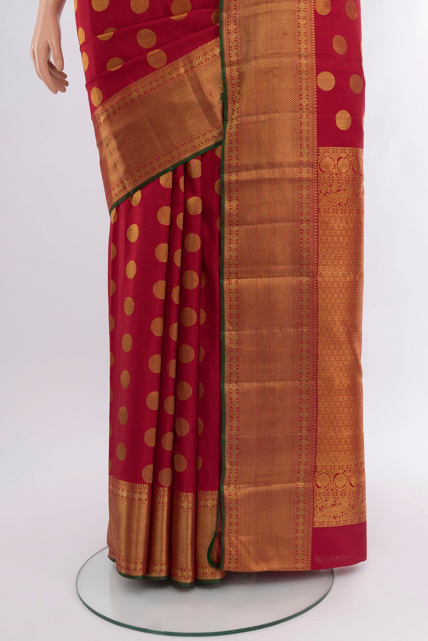 Pleats and pallu of Maroon Kanchipuram Silk Saree with Zari Butta on the body and Zari Border. 