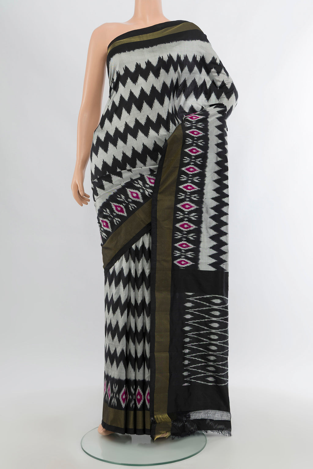 Grey Pochampally Silk Saree with Pure Ikat on the body and Ikat Border.  displayed on a mannequin