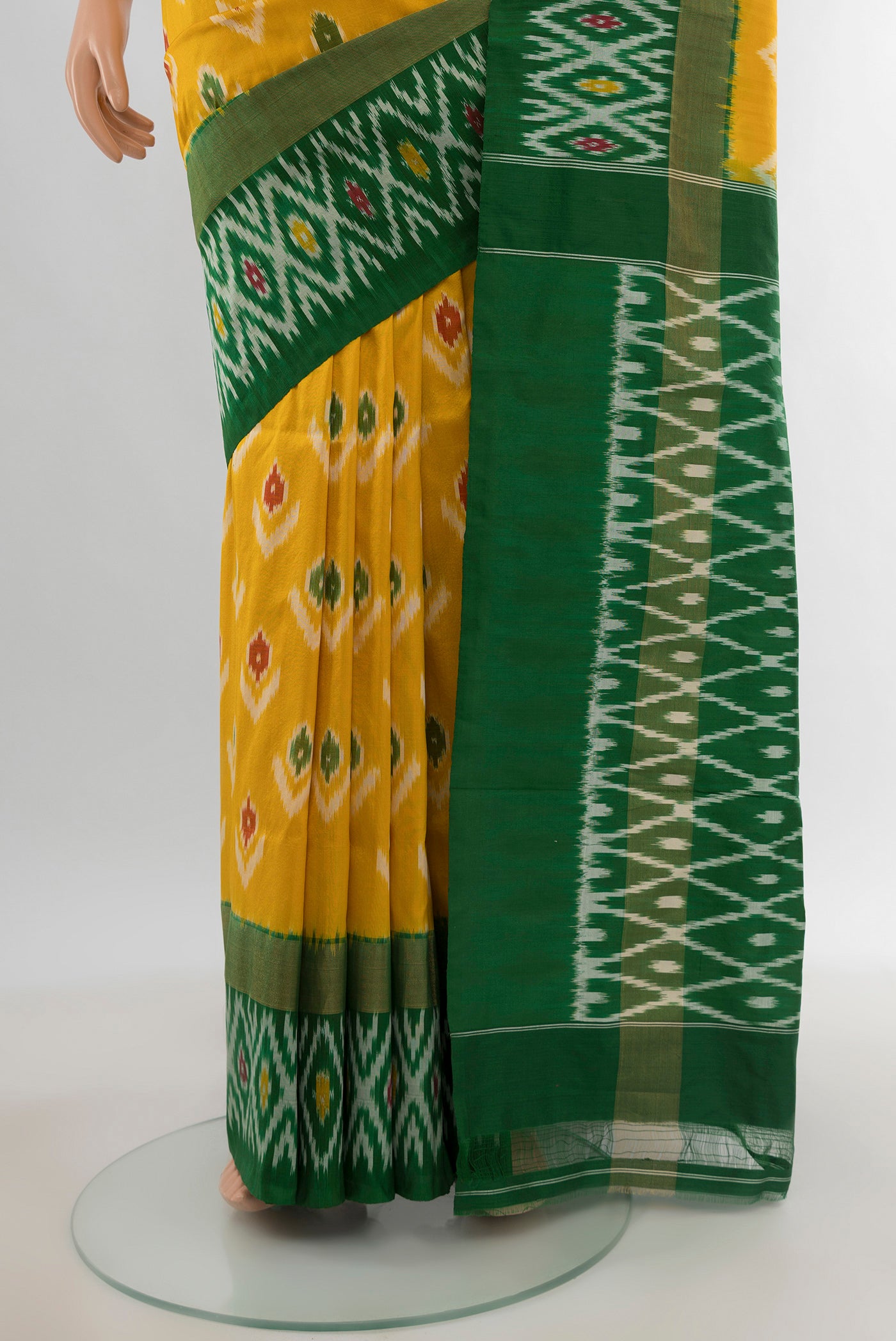 Pleats and pallu of Mustard Pochampally Silk Saree with Ikat design on the body and Ikat Border. 