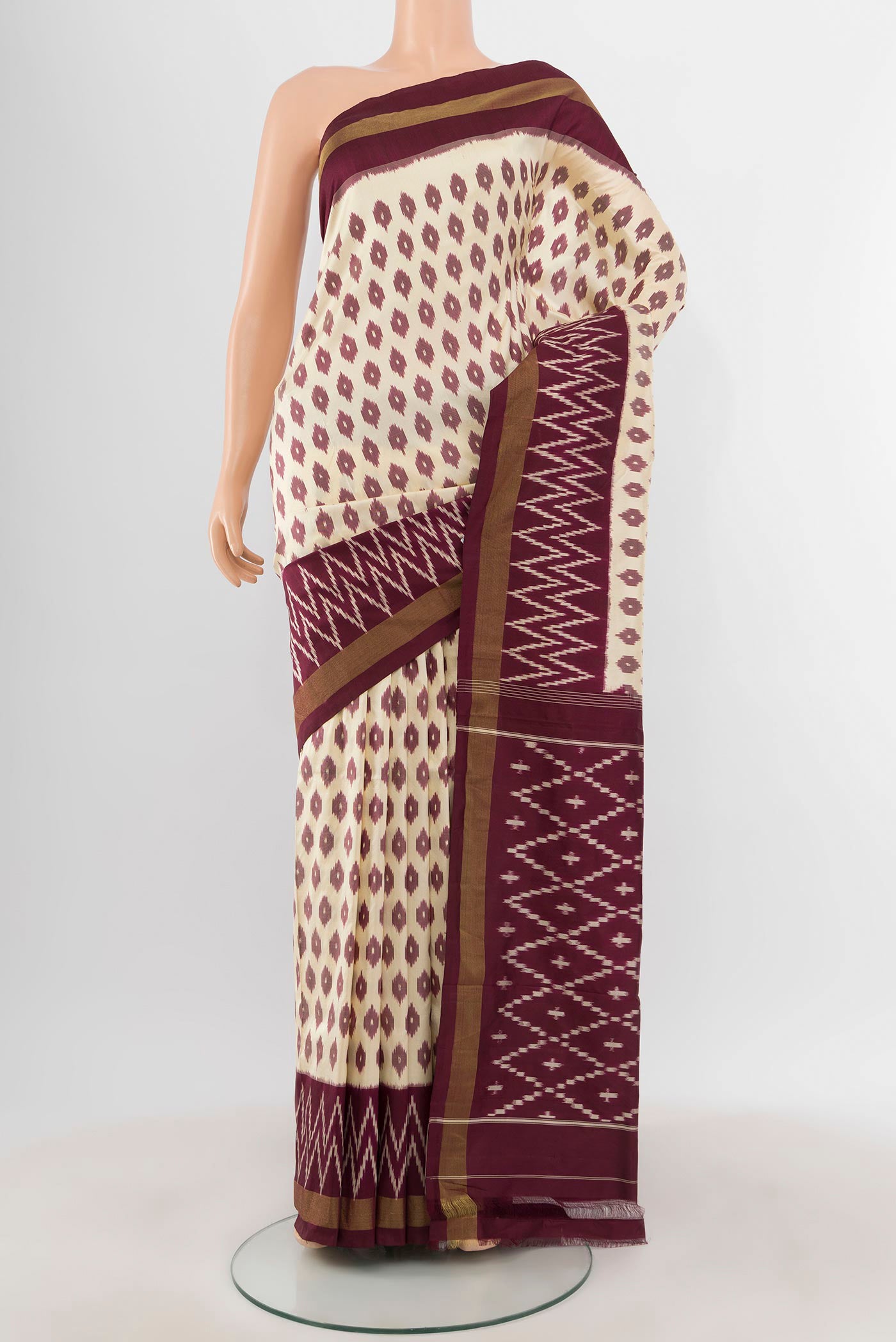 Cream Pochampally Silk Saree with Pure Ikat on the body and Ikat Border.  displayed on a mannequin