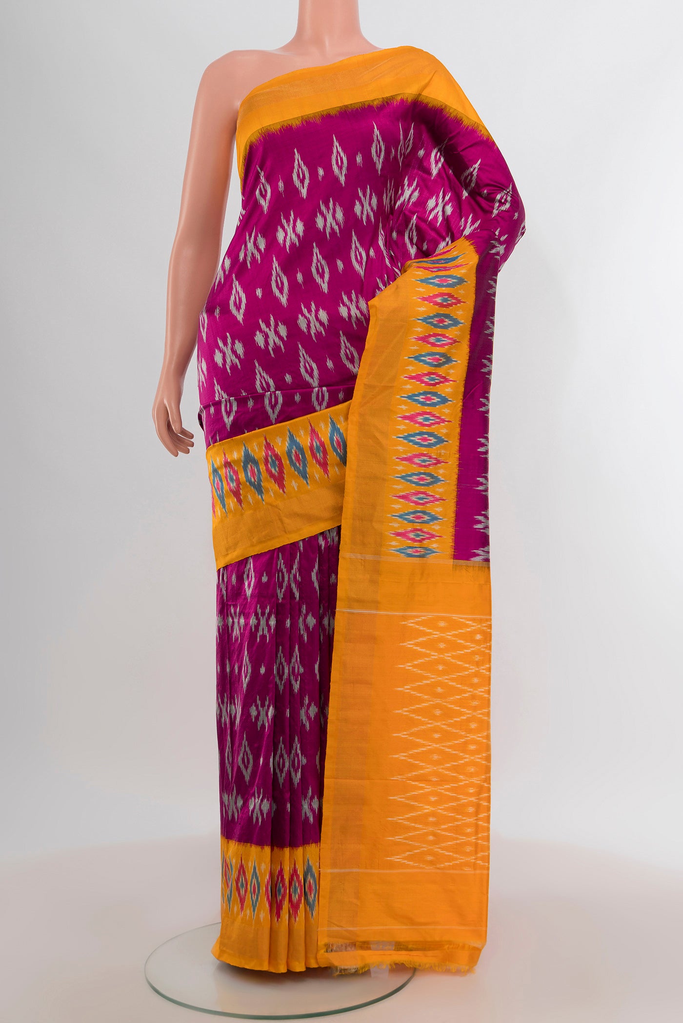 Purple Pochampally Silk Saree with Ikat design on the body and Ikat Border.  displayed on a mannequin