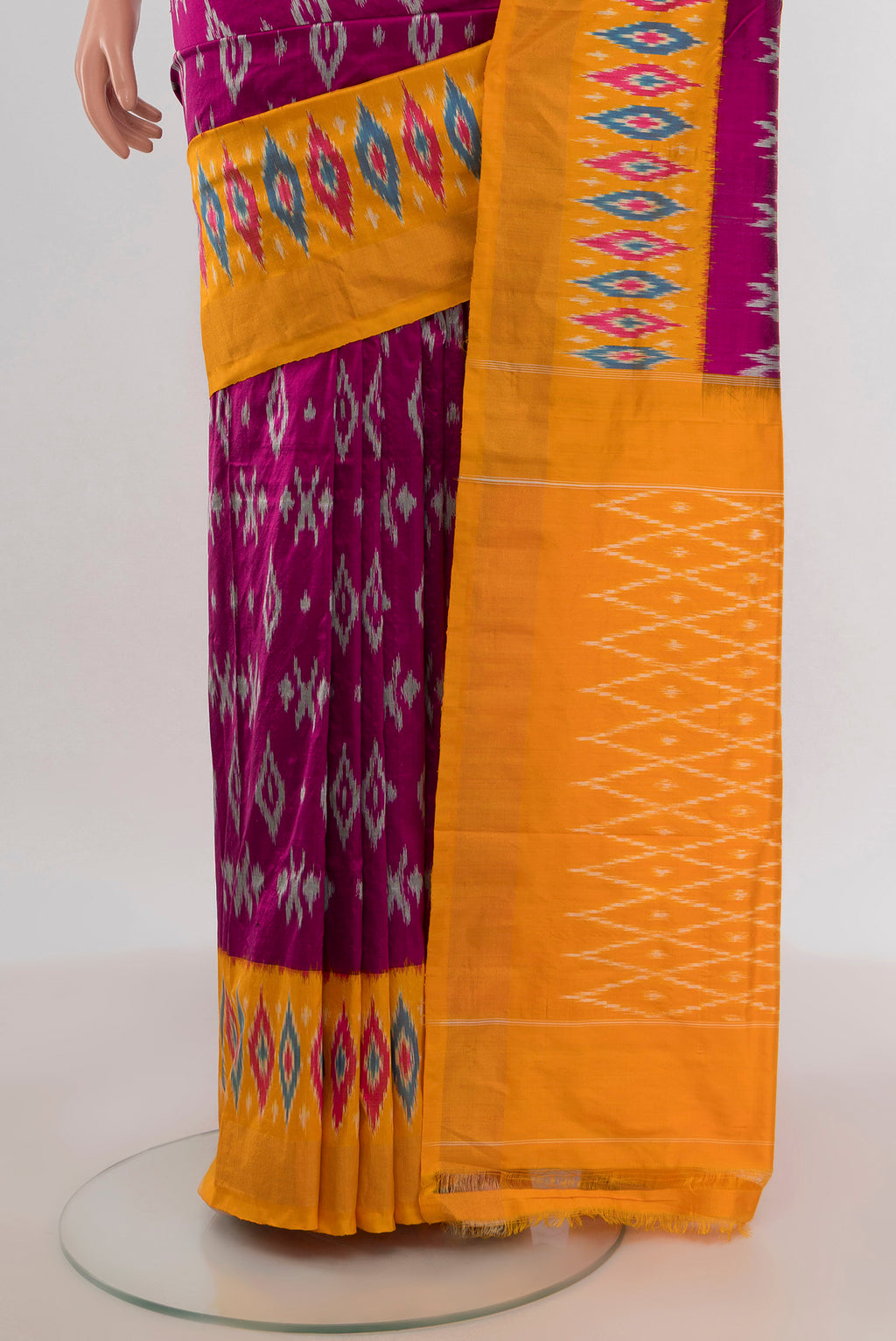 Pleats and pallu of Purple Pochampally Silk Saree with Ikat design on the body and Ikat Border. 
