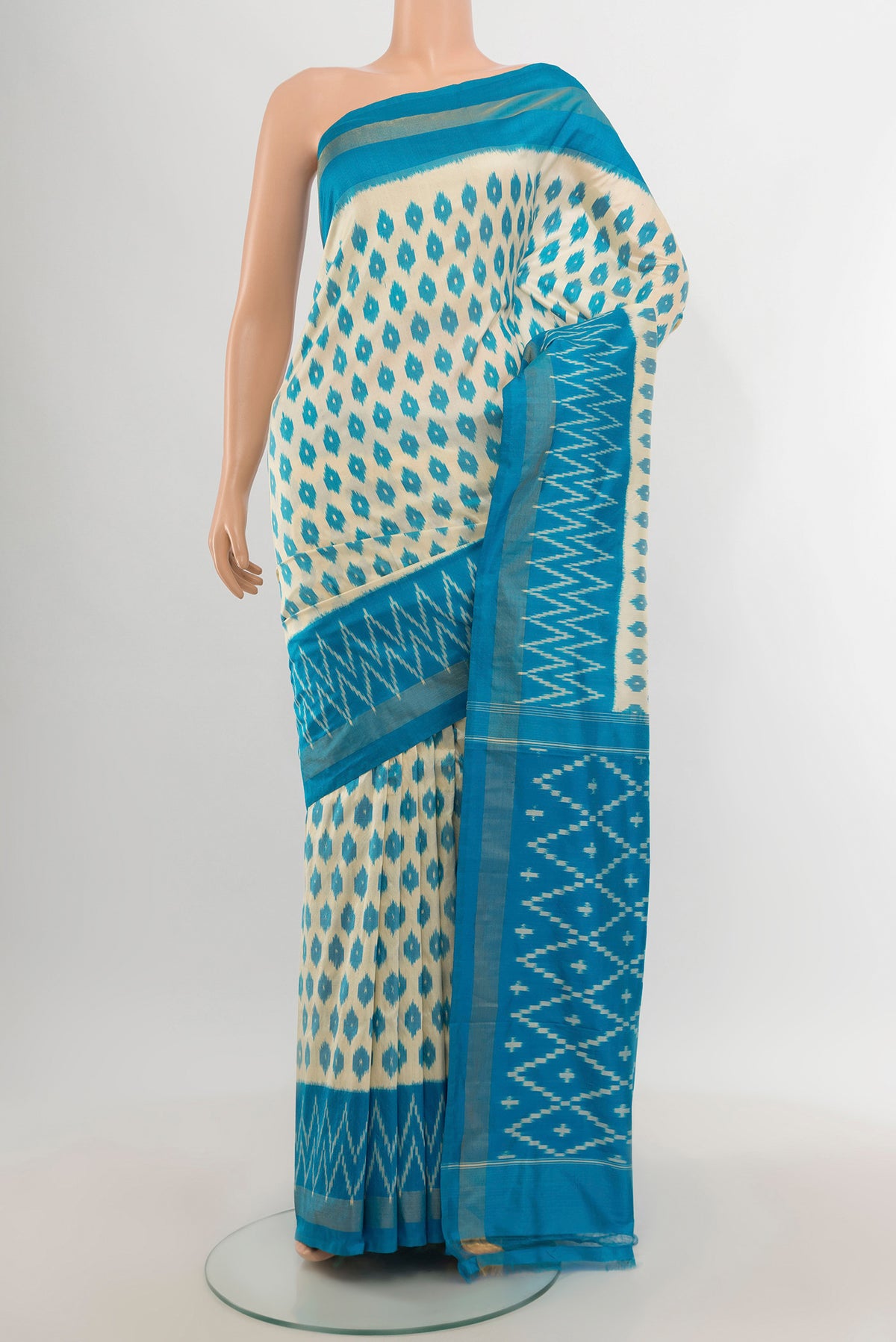 Cream Pochampally Silk Saree with Ikat design on the body and Ikat Border.  displayed on a mannequin