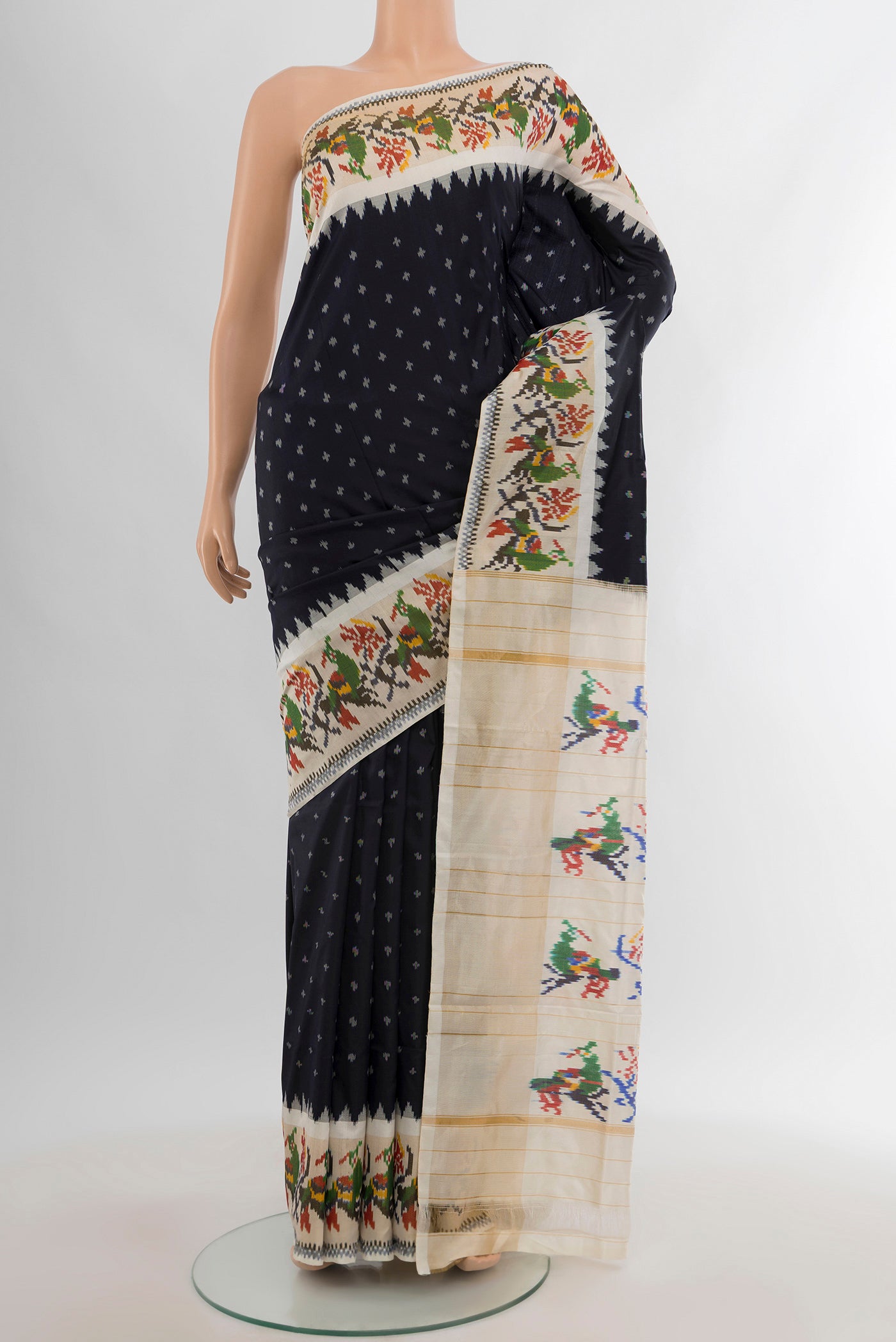 Black Pochampally Silk Saree with Ikat design on the body and Ikat Border.  displayed on a mannequin